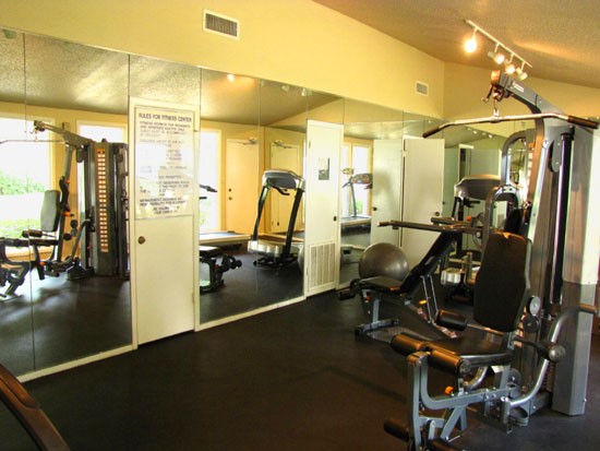 Pier Landing Apartments interior of fitness room with workout equipment and mirrors on walls