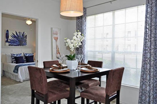 Riverwalk Apartments dining room area with huge window looking into bedroom