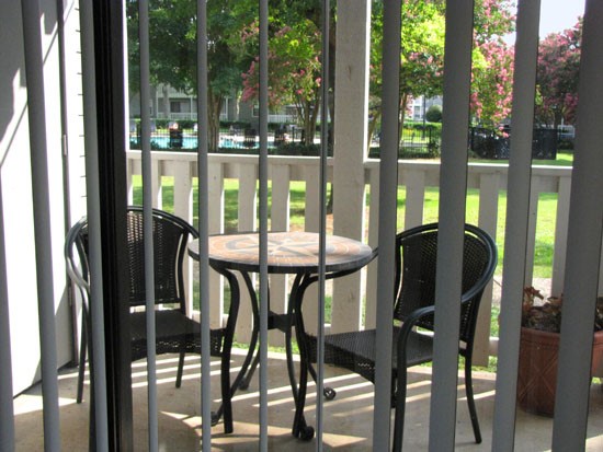Pier Landing look onto back patio with blinds, and white fence