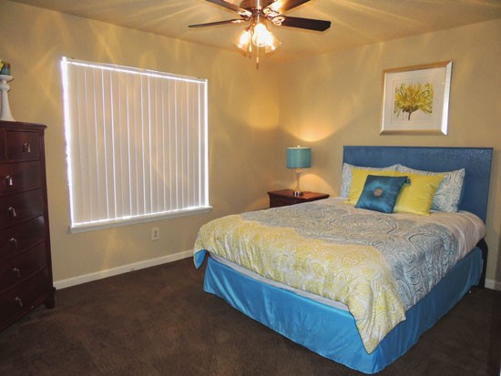 Ashton Pines big model bedroom with ceiling fan and window