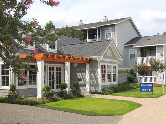 Pier Landing Apartments stunning outside look of grey front office buildings with an orange overhead patio area