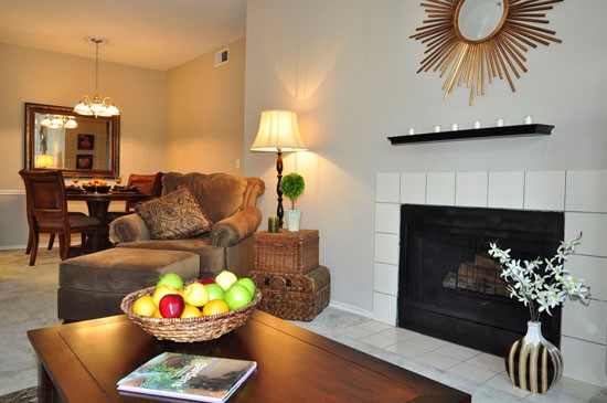 Champion Lake Apartments Model Living Room with Beautiful Fireplace Surround By White Tile