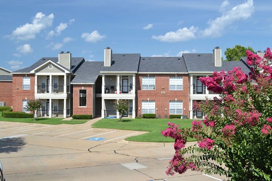 Champion Lake Apartments Full View Of Brick Red Apartment Buildings