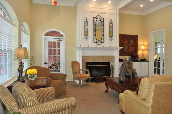 Champion Lake Clubhouse Front Room With Comfortable Lounge Chairs and Doors Entering Into Another Room
