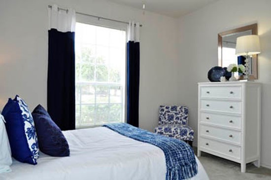 Riverwalk Apartments first model bedroom with room and large window