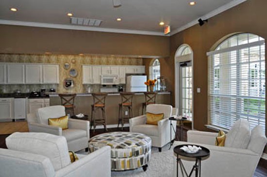 Riverwalk interior of stunning modern living room in clubhouse looking into kitchen