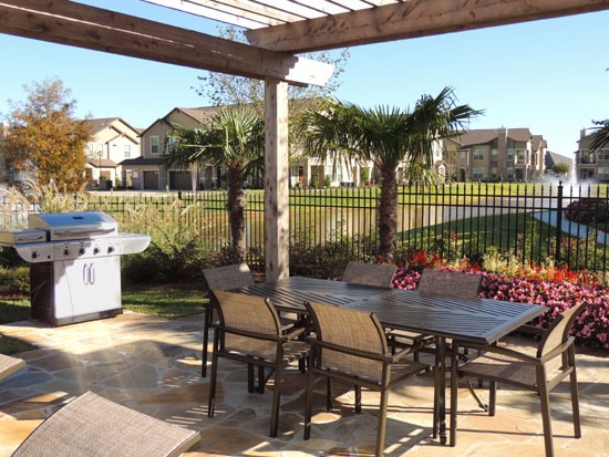 Boulders on Fern Apartments Arbor with tables and chairs and large grill, look at lake