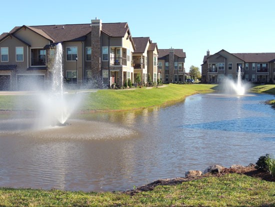 Boulders on Fern Apartments river with two large water fountains