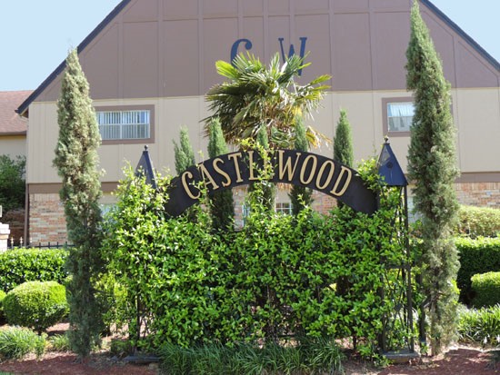 Castlewood Apartments Beautiful Front Sign Covered with Trees