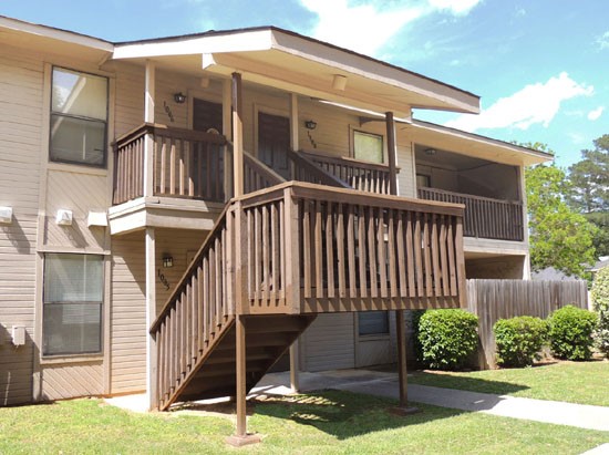 Cedar Creek Big Mahogany Stairs Leading up to the Second Floor With Balconies