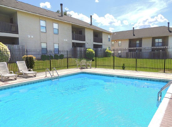 Cedar Creek Beautiful Pool Side View Surrounded by Apartments Buildings