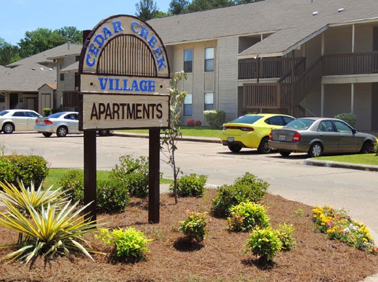 Cedar Creek Beautiful Bright Blue Front Sign with Parking Lot Behind