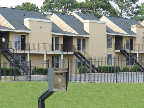 Chimney Hill Gate Entrance With Key Pad, With Big Tan Apartment Buildings