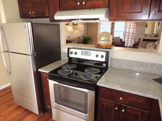 Chimney Hills Apartments Big Open Model Kitchen with Bar Space Looking into Living Room