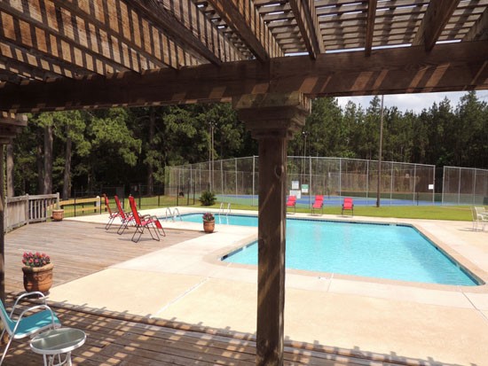Chimney Hill Under Overhead Area Next to Pool With Lounge Chairs