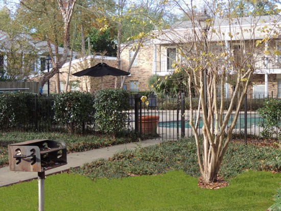 Cornerstone Apartments gate entrance into pool area, with little grill