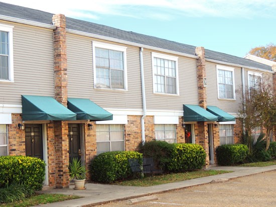 Cornerstone front side of two story one apartment apartment building with own parking lot