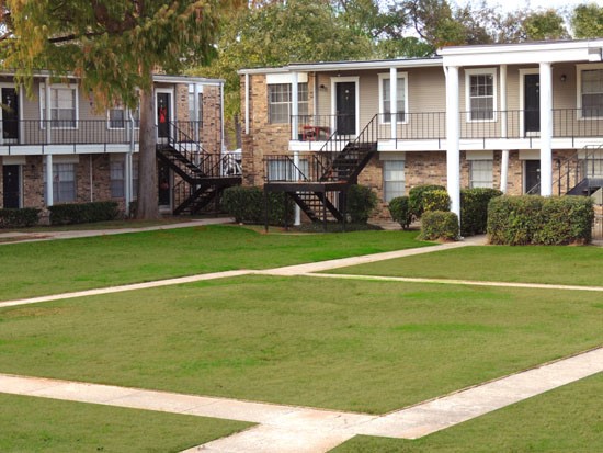 Cornerstone big open courtyard with sidewalk, apartment buildings surrounding