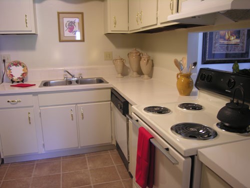 Live Shreveport Apartments big open tile floor model kitchen with window