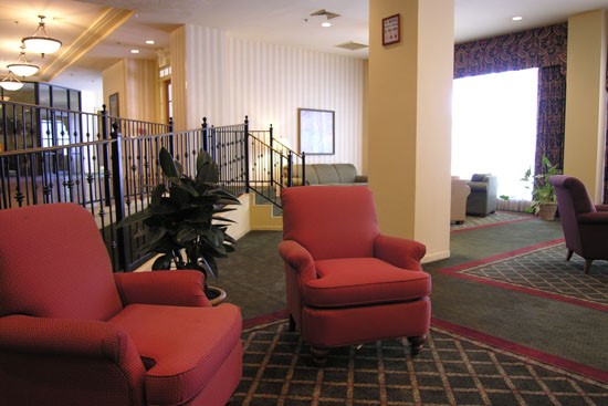Fairmont Apartments lounge room with ramp leading up to other parts of building