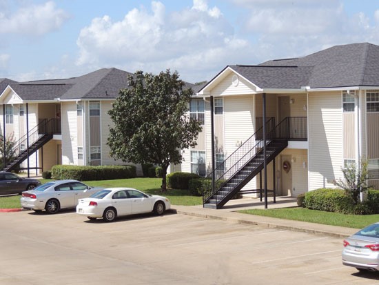 Fox Creek Apartments view from second story overlooking parking lot and other buildings