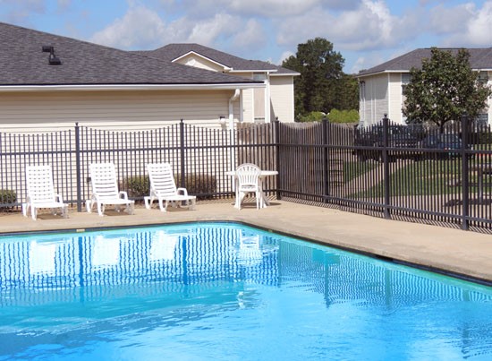 Fox Creek really blue gated pool with white lounge chairs