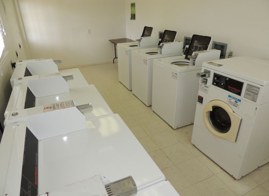 Fox Creek interior of laundry facility with washer and dryers, pay with quarters