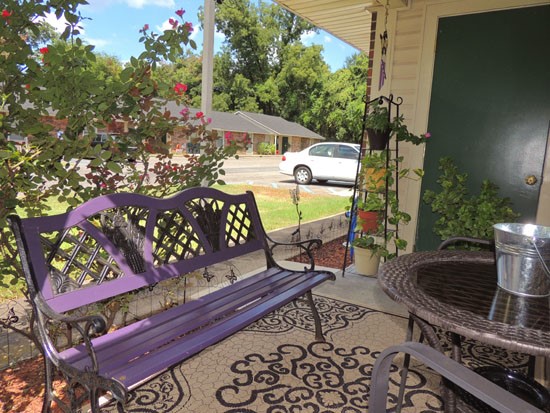 Heritage Village Apartment Patio looking out into parking lot, storage room