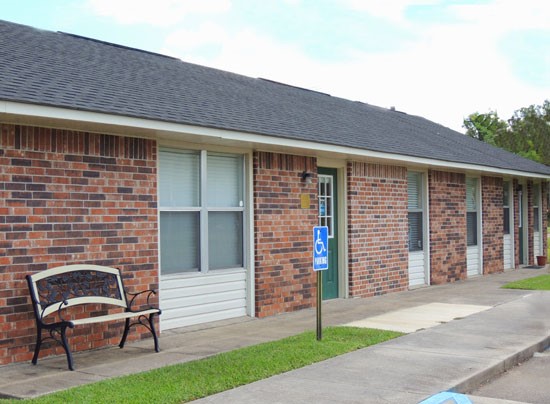 Heritage Village Apartments side view of red and brown bricks front office buildings