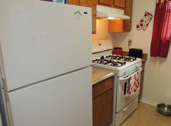 Heritage Village look into beautiful model kitchen with wood cabinets and kitchen appliances