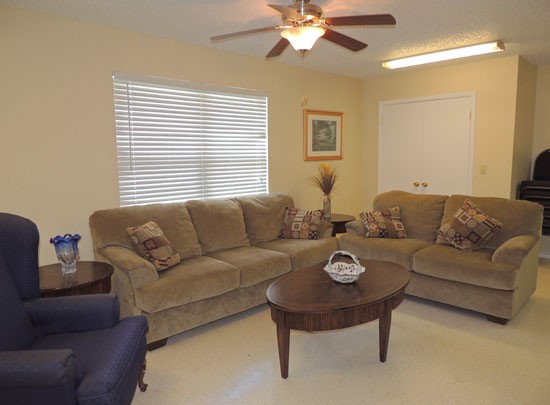 Heritage Village Apartments clubroom with soft and comfy lunge chairs and couches