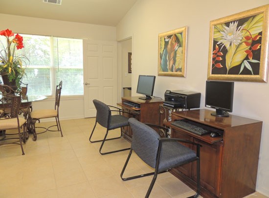 King Oaks work area with chairs and computers, and a printer inside clubroom
