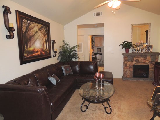 King Oaks Apartments huge model living room area with beautiful brick fireplace