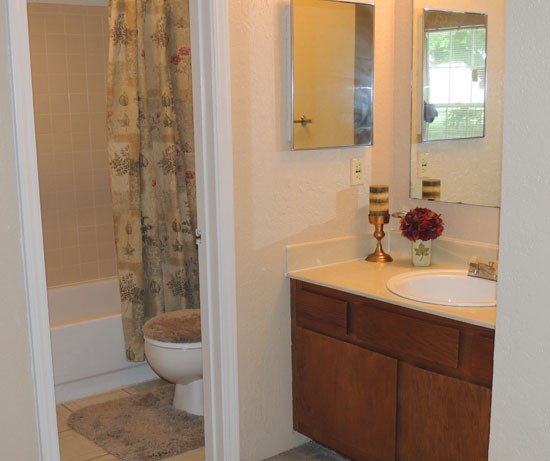 Kingston Village Apartments beautiful model bathroom with two mirrors and toilet/shower separated from sink