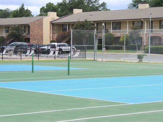 Kingston Villages blue and green full sized tennis courts with nets and fence