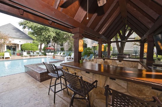 La Crosse Apartments outdoor overhead kitchen area with bar and stools