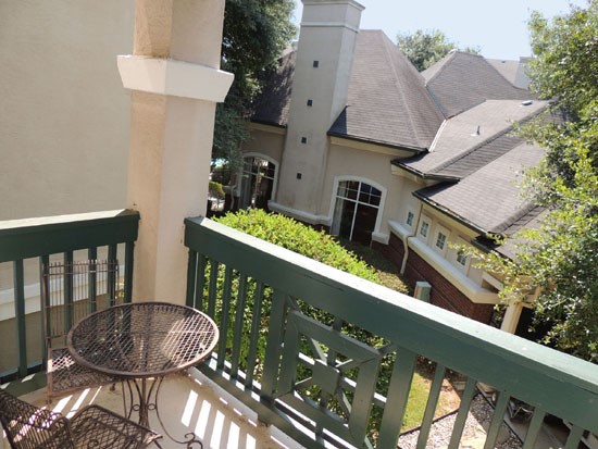 La Crosse Apartments balcony with green railing, overlooking clubhouse