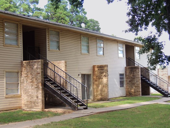 La Tierra front side view of apartment building with stairs going up to second floor