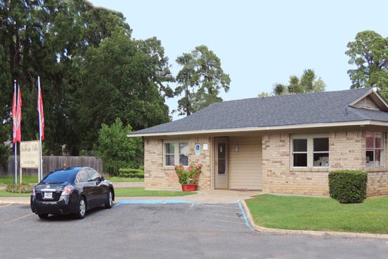 La Tierra Apartments side front view of front office buildings with parking, front sign
