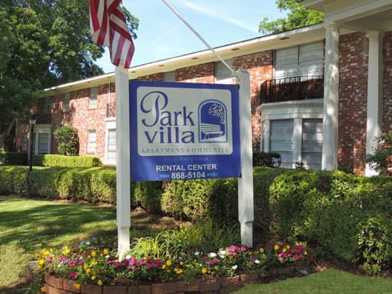 Park Villa Apartments blue and white tall white front sign entering into apartments