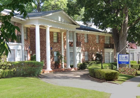 Park Villa Front side view of colonial style front office building with circle driveway and front sign