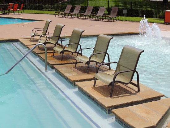Riverbend in pool lounge chairs with fountains and steps into pool
