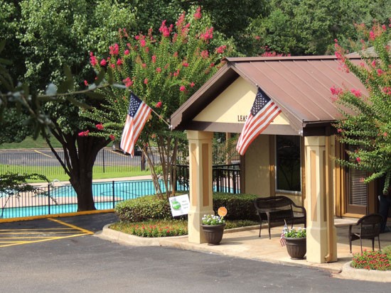 Riverbend front office building from high up, gated pool in background