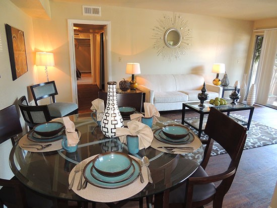 Riverbend Apartments model dining room area looking into beautiful living space and down hallway towards bedrooms