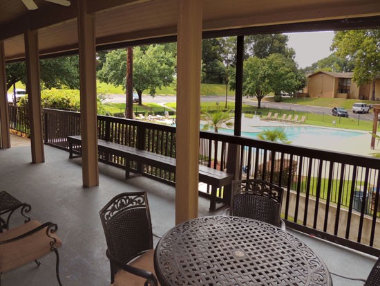 Riverbend Apartments overhead patio area looking over the pool area with tables and chairs