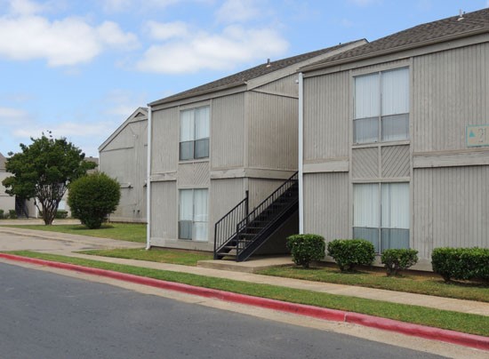 Tree Tops front side of two story apartments buildings from parking lot
