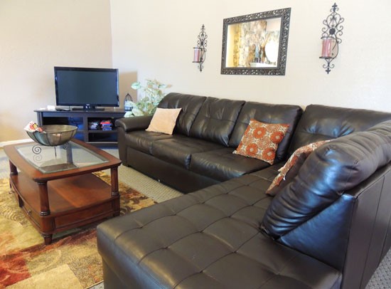 Tree Tops living room area interior of clubhouse with large couch and tv