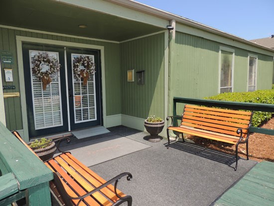 Tree Tops Apartments clubhouse big porch with wood benches