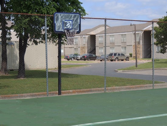 Tree Tops green high fenced basketball court