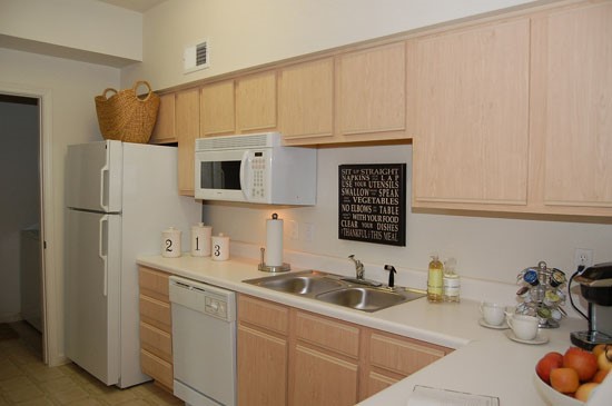 Westlake big model kitchen with light wood cabinets and walk in pantry
